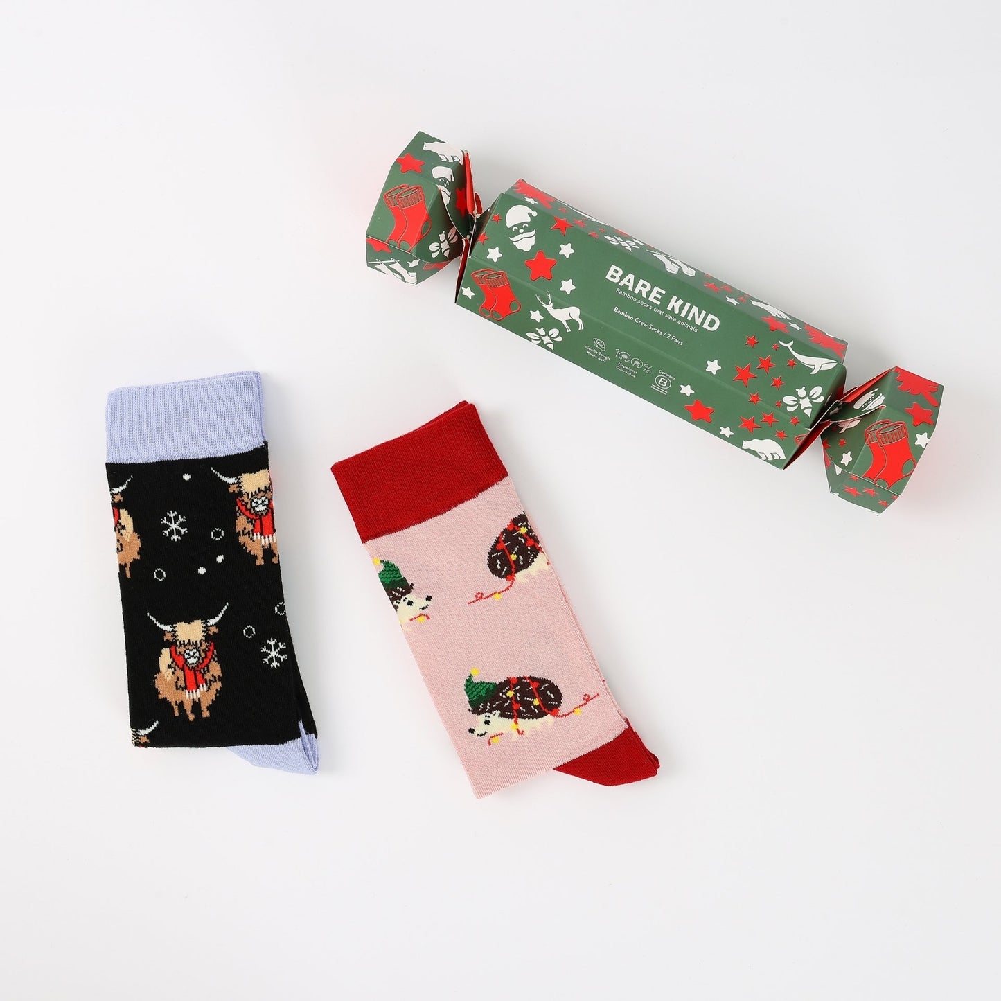 Two pairs of patterned socks with a 'Bare Kind' branded box on a white background