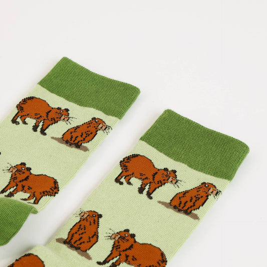 Pair of green capybara bamboo socks on a white background