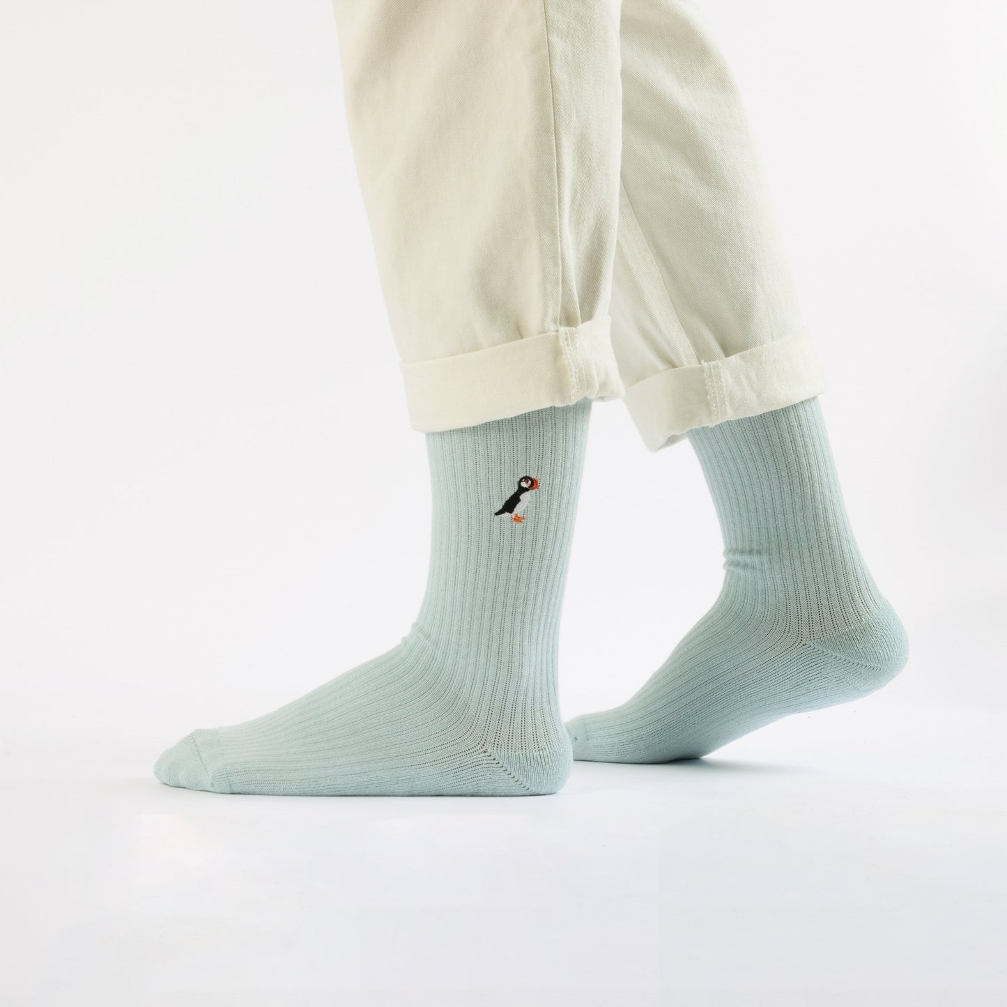 Model wearing blue puffin ribbed bamboo socks