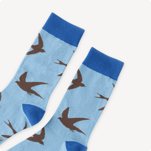 Light blue socks with brown swift pattern on a white background