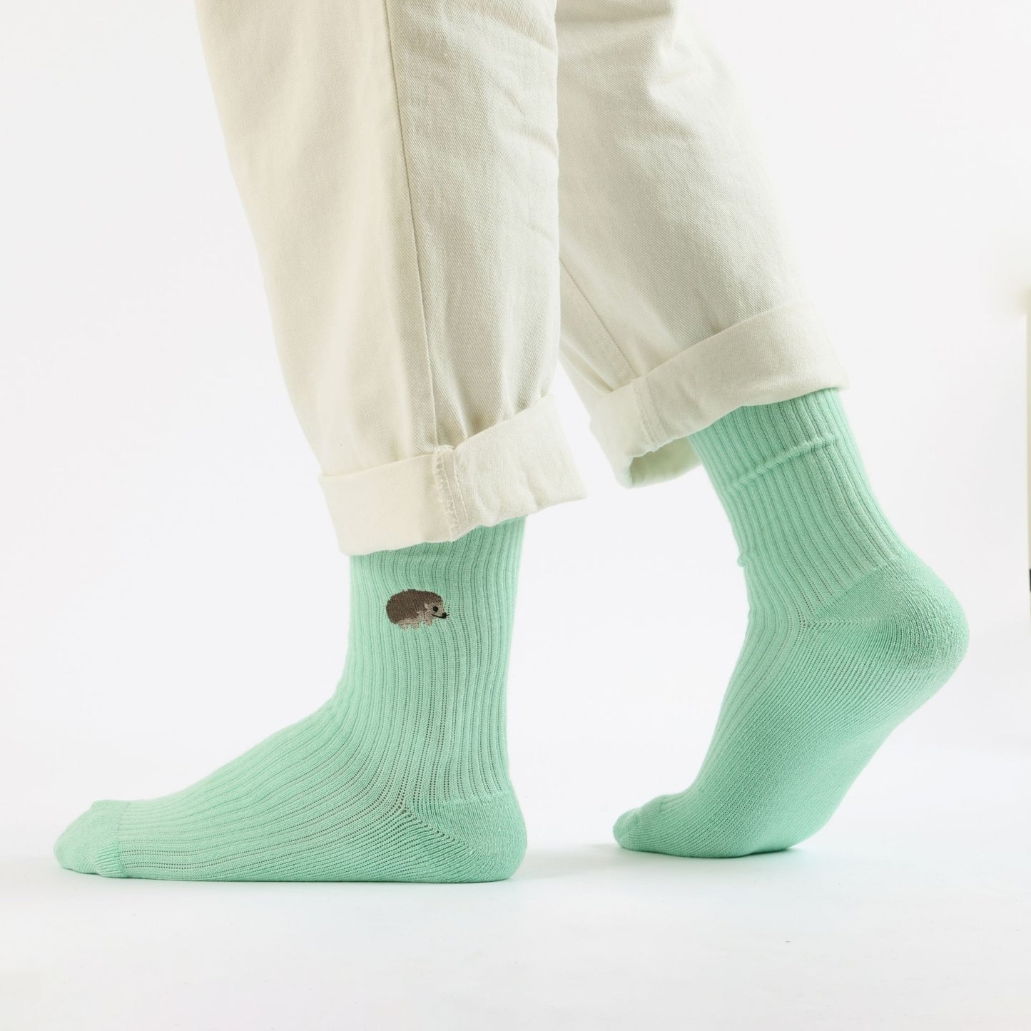 Model wearing green hedgehogs ribbed bamboo socks