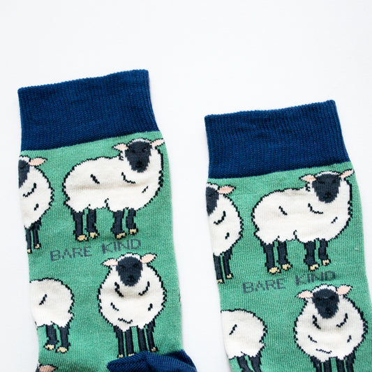 cuff closeup flat lay of green sheep socks with navy cuff