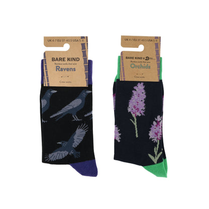 Two pairs of socks with 'Bare Kind' packaging, one featuring ravens and the other orchids, on a white background.