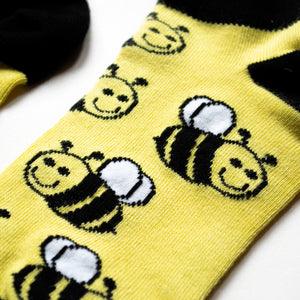 closeup of bumble bee black and yellow trainer socks