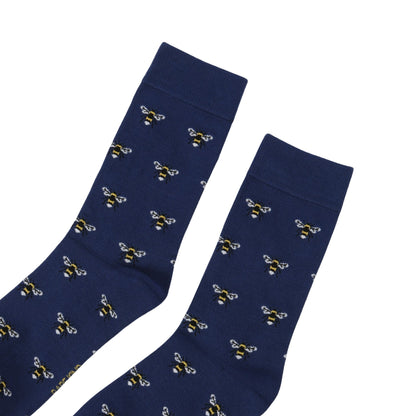 Navy blue socks with bee pattern on a white background