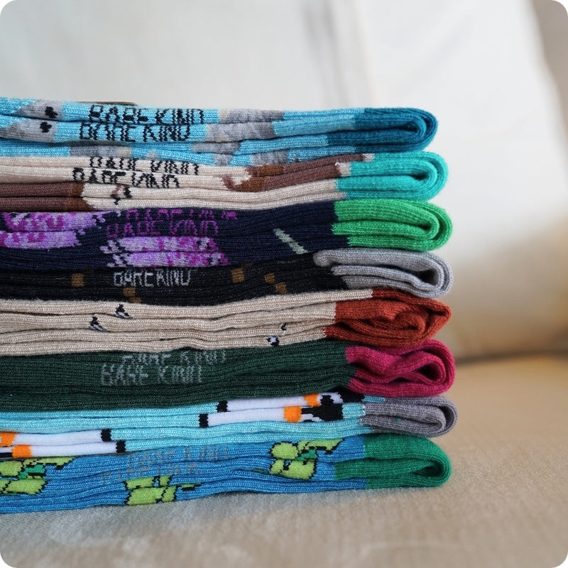 Stack of colorful socks with text on a neutral background