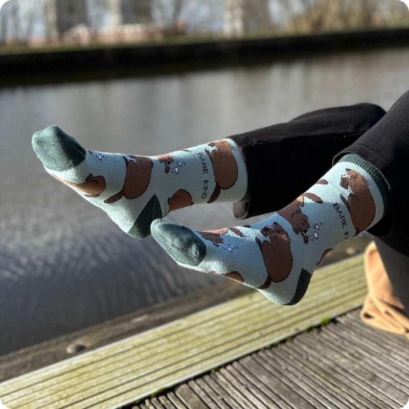 Person wearing patterned socks with a blurred natural background