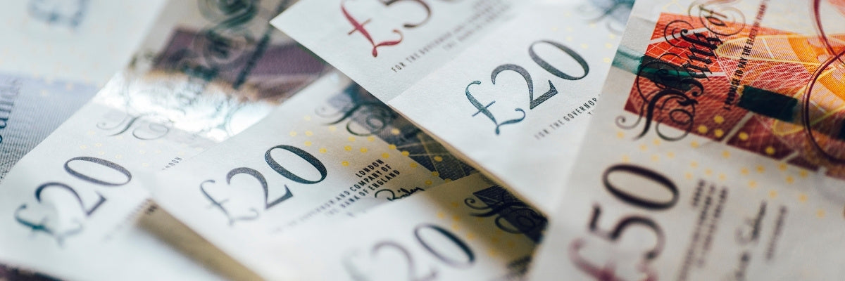 Close-up of various British banknotes with denominations including £20 and £50.