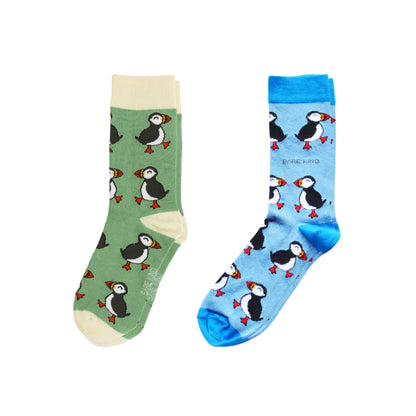 Two socks with puffin design, one green and one blue, on a white background.