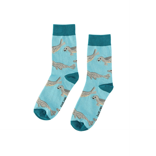 Pair of blue socks with seal pattern on a light blue background
