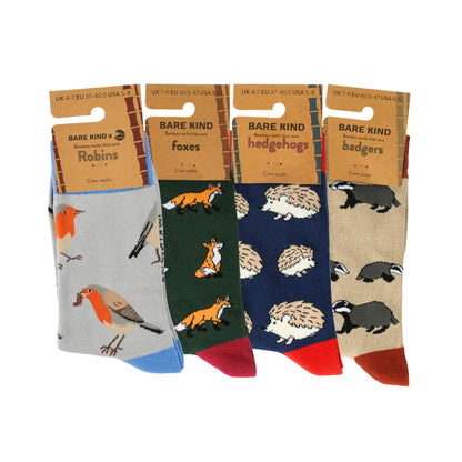 Four pairs of Bare Kind woodland-themed crew socks displayed side-by-side on their cardboard hangers against a white background.