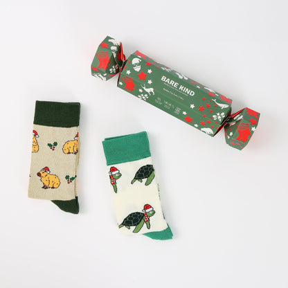 Two pairs of socks with animal patterns and a 'Bare Kind' branded box on a white background