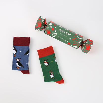 Two pairs of socks with animal patterns and a 'Bare Kind' branded box on a white background