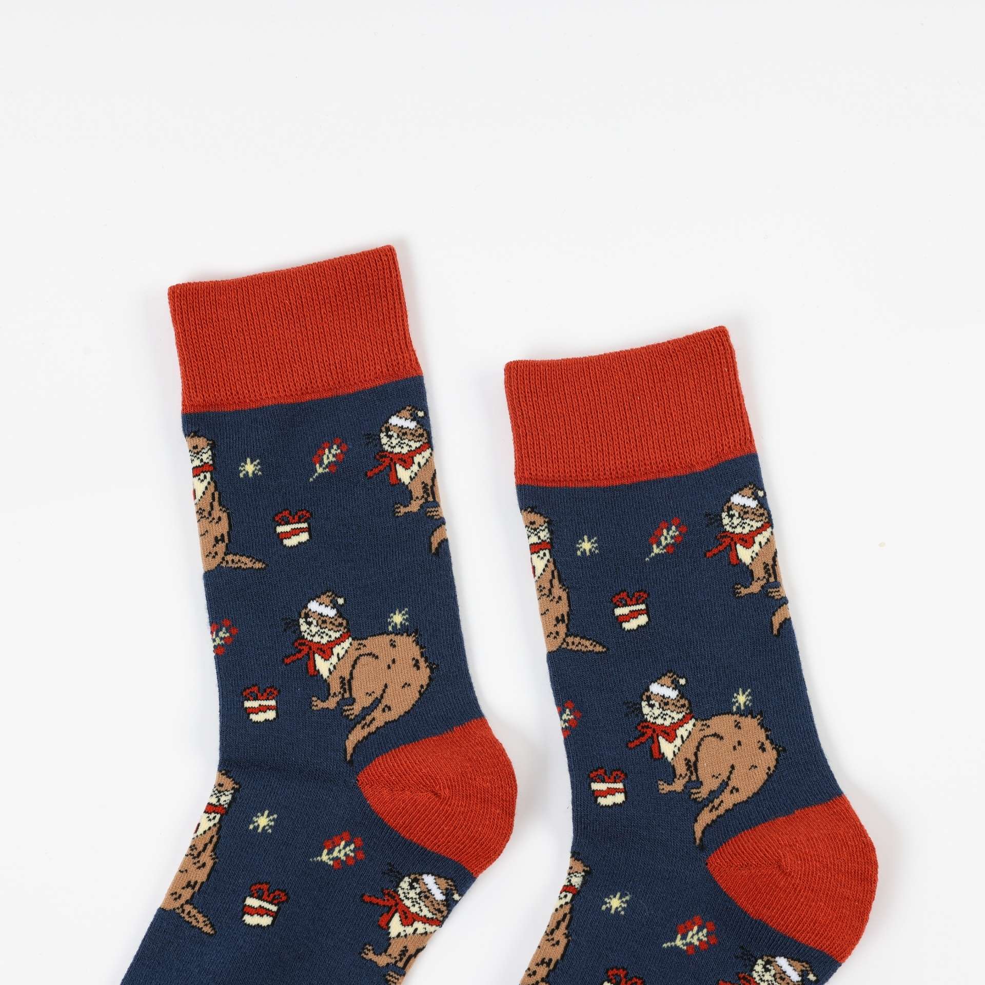 Pair of Christmas Otter socks socks with red accents on a white background