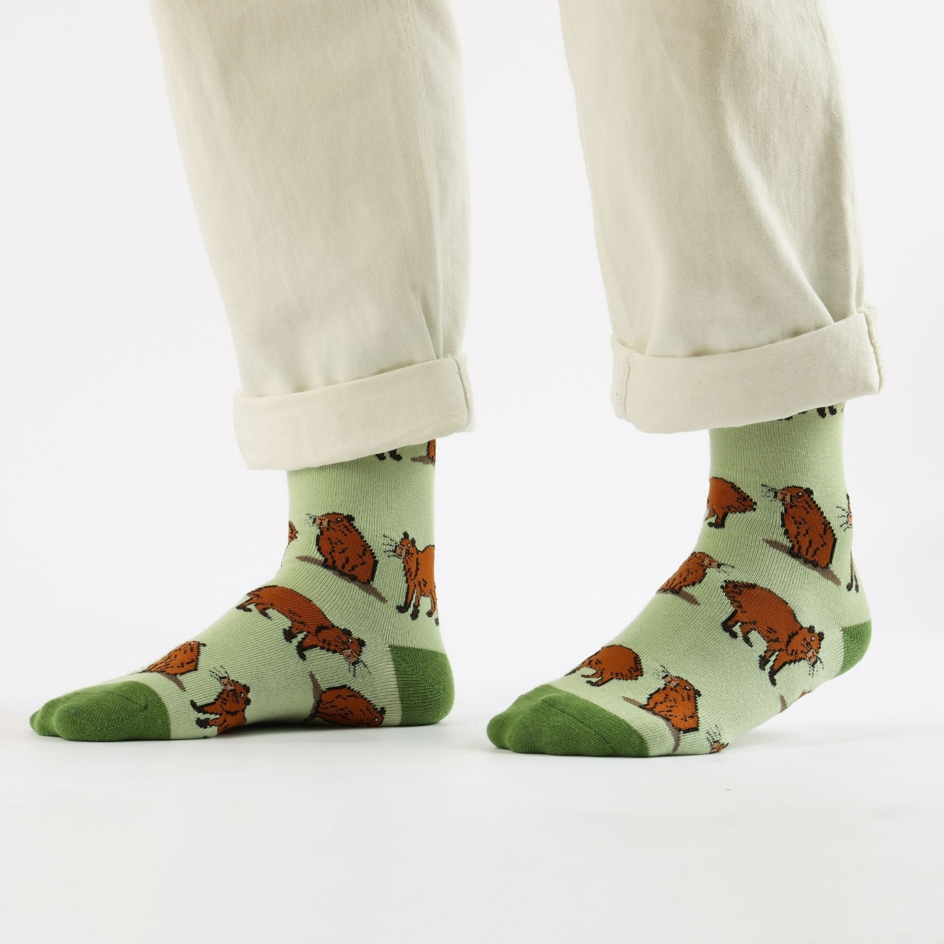 Green capybara bamboo sock worn by a person on a white background