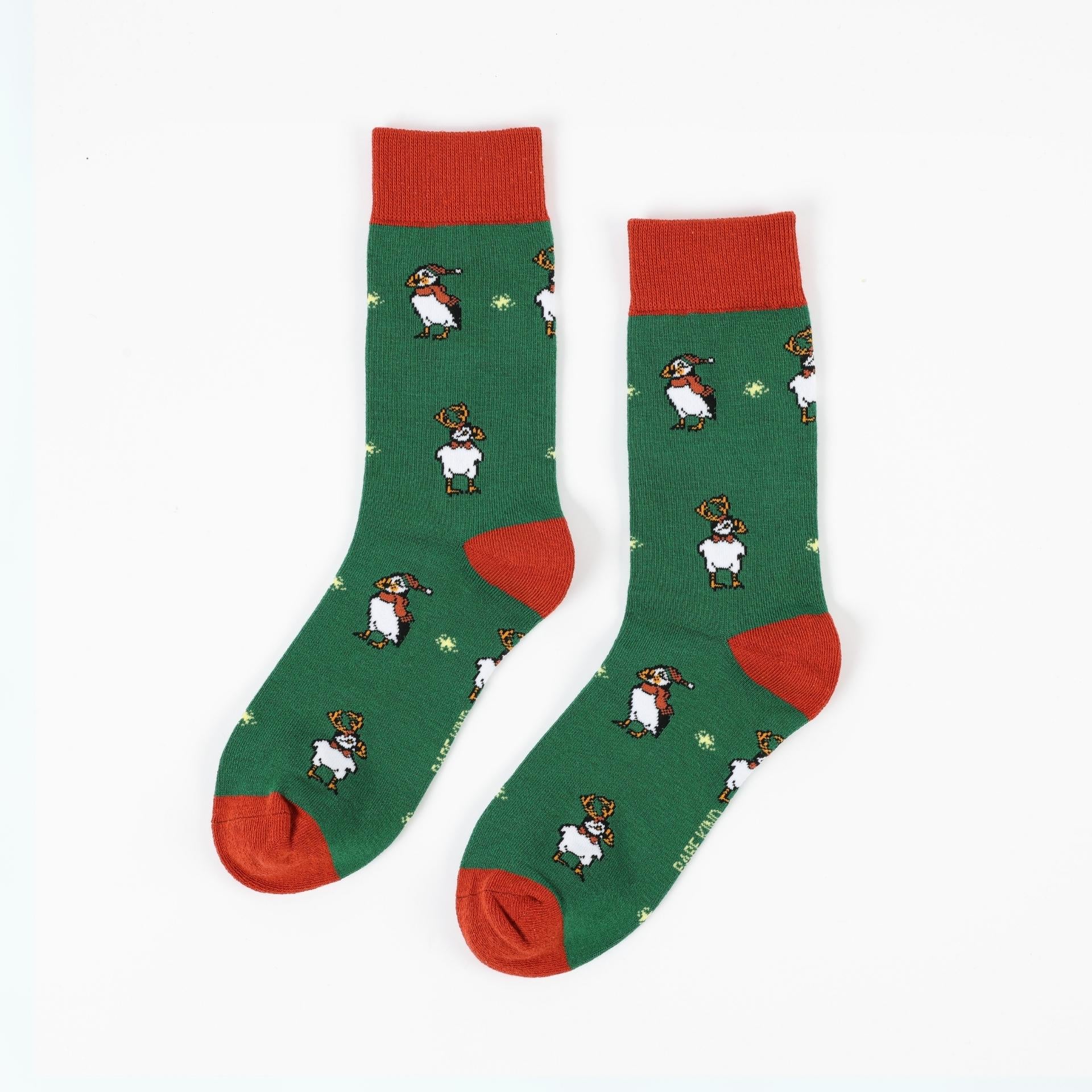 Green christmas puffin bamboo socks with red accents on a white background