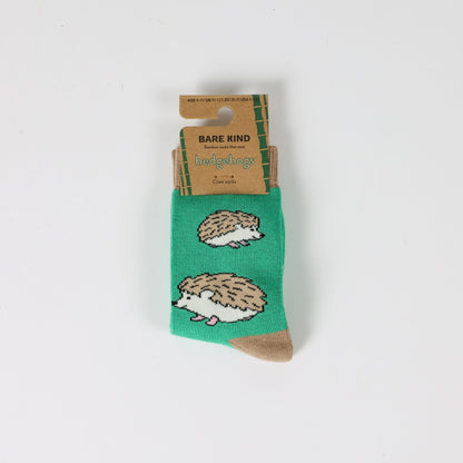 Green socks with hedgehog design on a white background