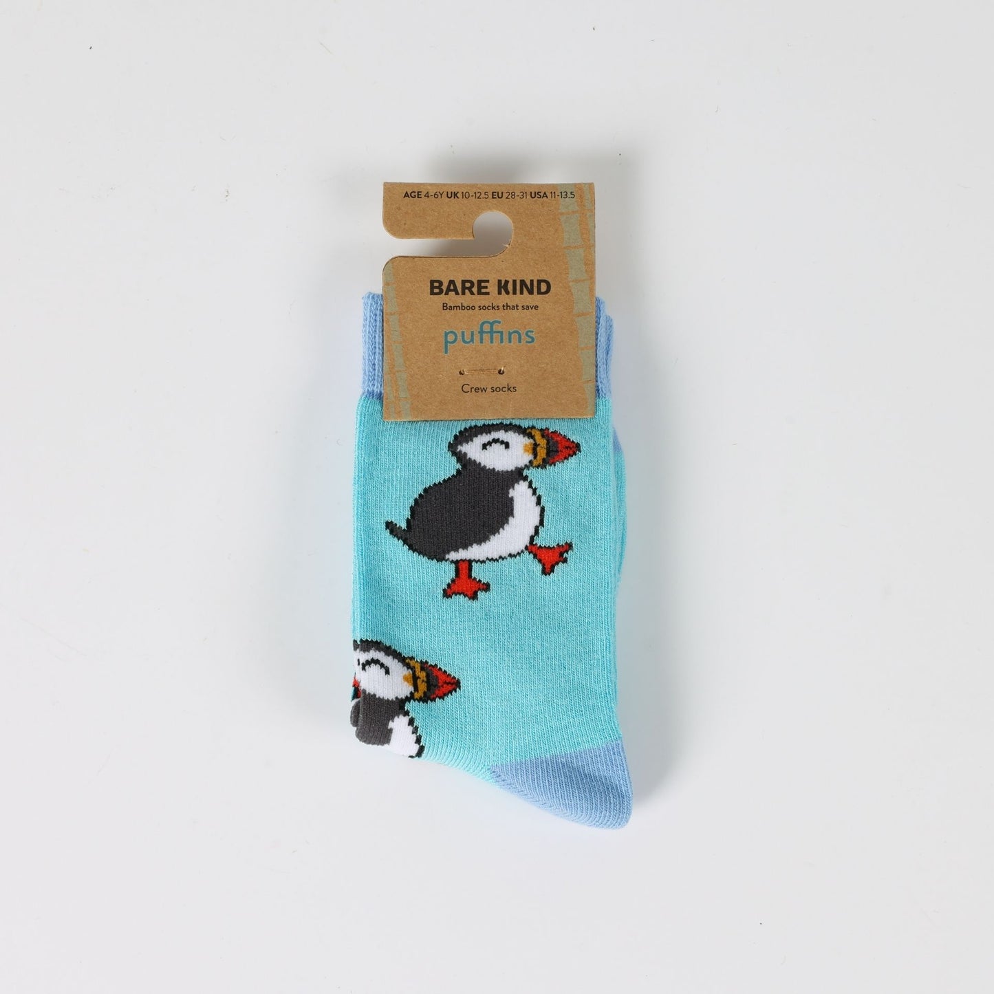 Pair of socks with puffin design and Bare Kind packaging on a light gray background