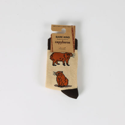 Capybara-themed socks with packaging on a white background