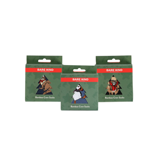 Three packages of Christmas bamboo crew socks on a white background