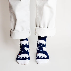 standing model, front view, wearing navy and white christmas polar bear socks