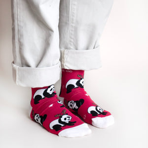 standing model wearing christmas socks featuring panda design, side angle view