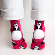 rear view of standing model on tip toes wearing christmas panda socks, featuring a panda sitting above the heel while wearing a reindeer headdress