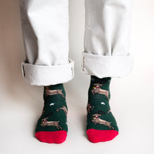 standing model wearing christmas reindeer socks, front view 