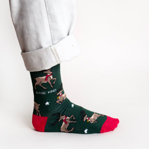 standing model wearing christmas reindeer socks, side view