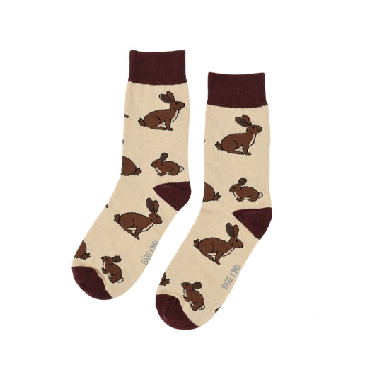Beige socks with brown hare patterns on a white background