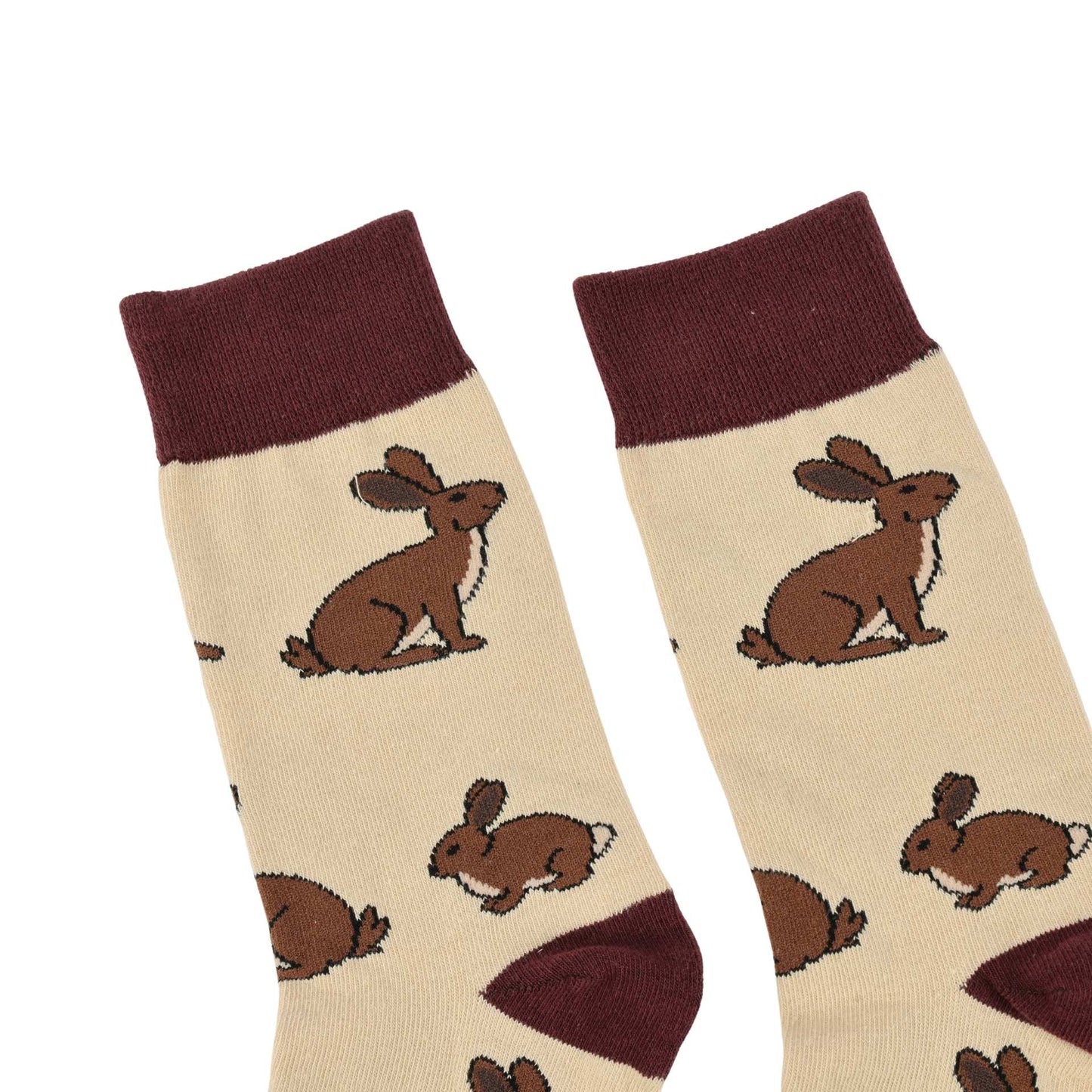Pair of socks with brown hare illustrations on a beige background