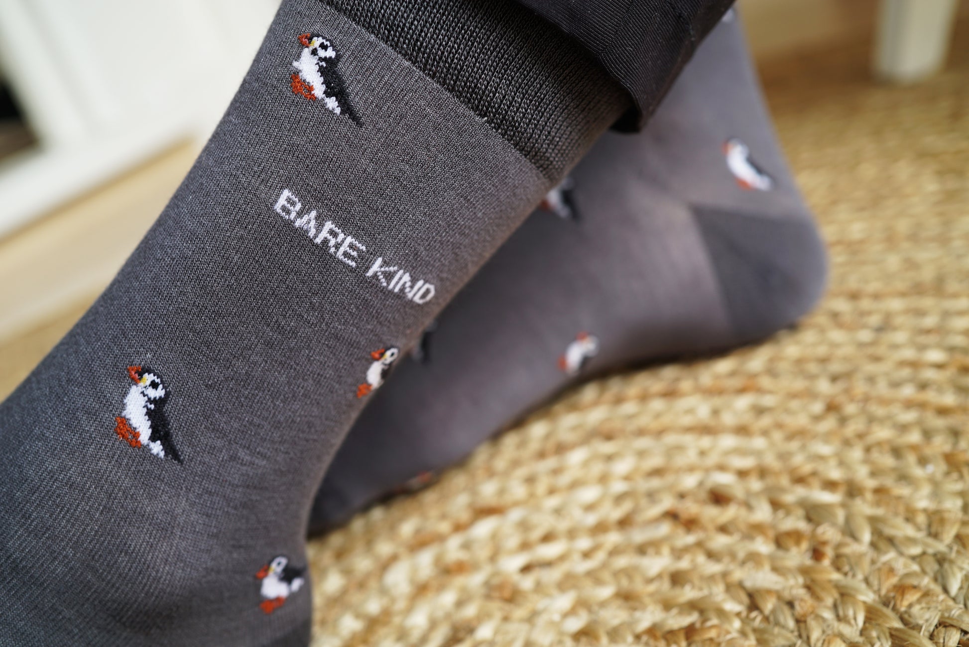 Close up to Bare Kind bamboo socks, featuring small motifs of puffins