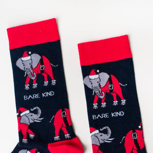 cuff closeup flat lay of navy and red christmas socks featuring an elephant wearing a santa outfit
