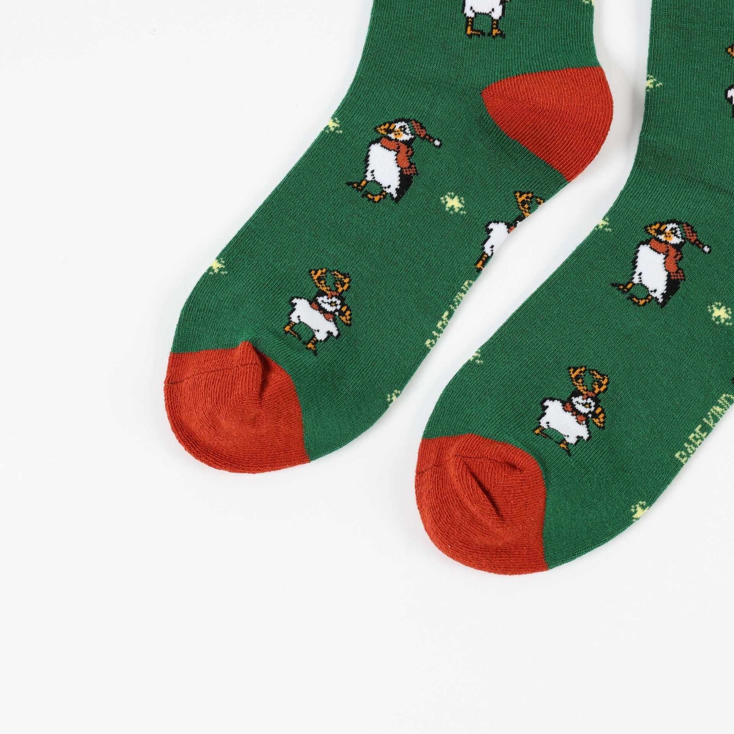 Green christmas puffin bamboo socks on a white background.