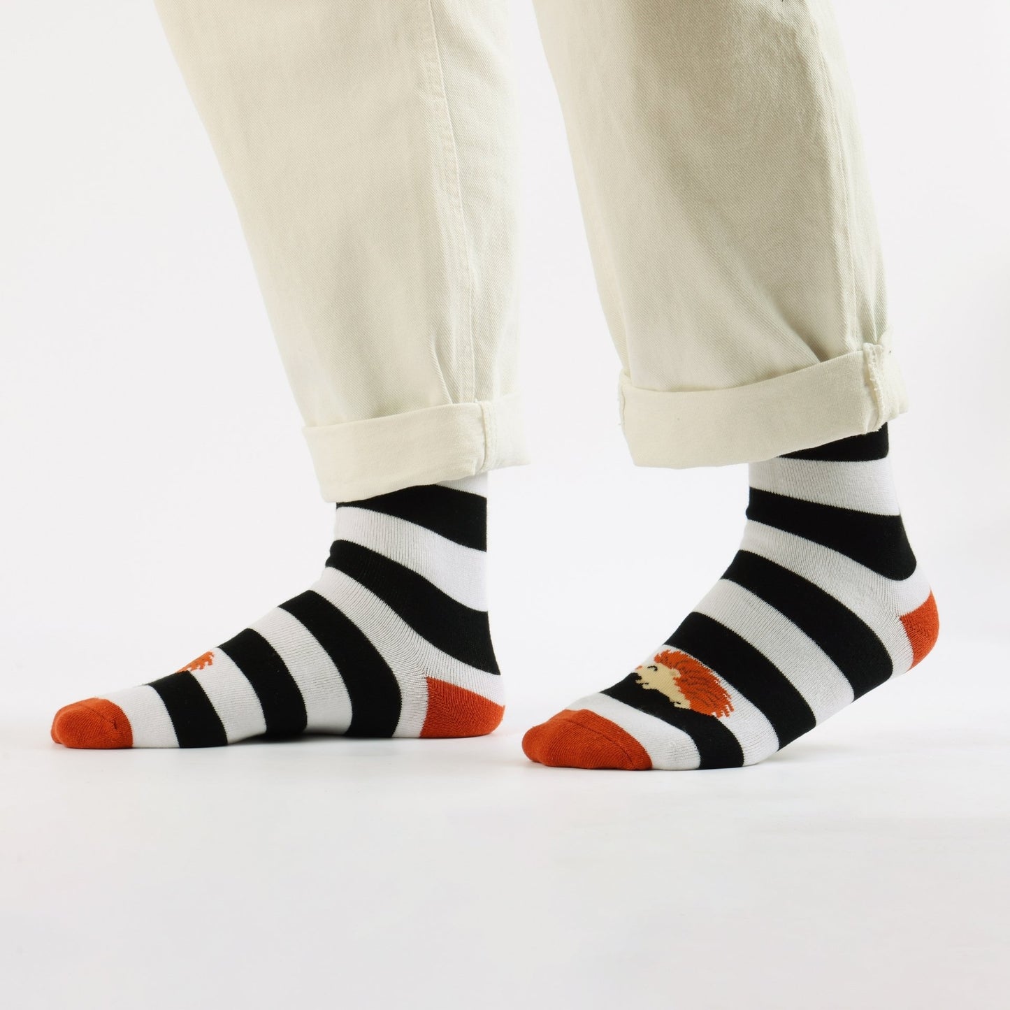 Pair of Hedgehog stripes socks worn by a person on a white background