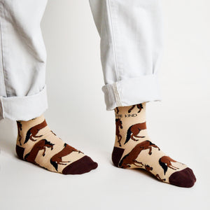 standing model walking with brown bamboo horse socks