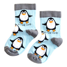 flat lay of sky blue bamboo kids socks in penguin design