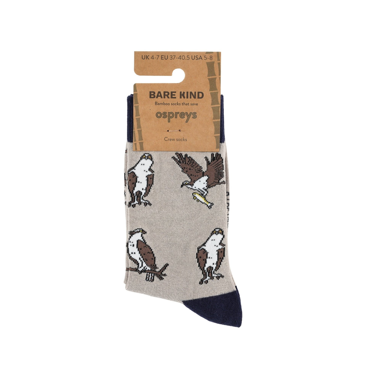 A pair of Bare Kind osprey crew socks on a cardboard hanger. The socks are light beige with brown and white osprey illustrations and a dark navy blue toe and heel.