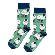 flat lay of green sheep socks with navy cuff and heel and toe