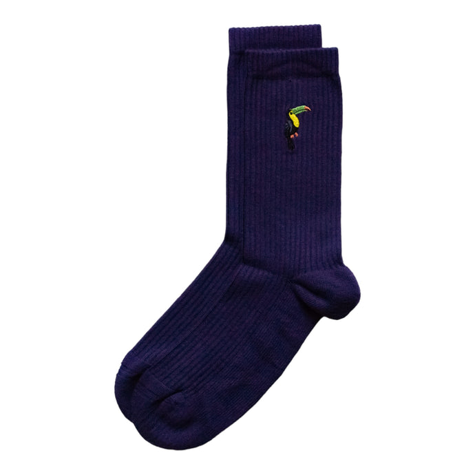 flat lay of deep purple ribbed bamboo socks with embroidered toucan motif on the cuff