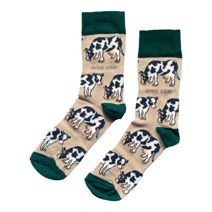 Flat lay of cream and green cow bamboo socks