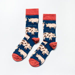 flat lay of navy blue pig bamboo socks with terracotta coloured cuffs, heels and toes