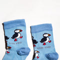 cuff closeup flat lay of blue bamboo puffin socks for kids
