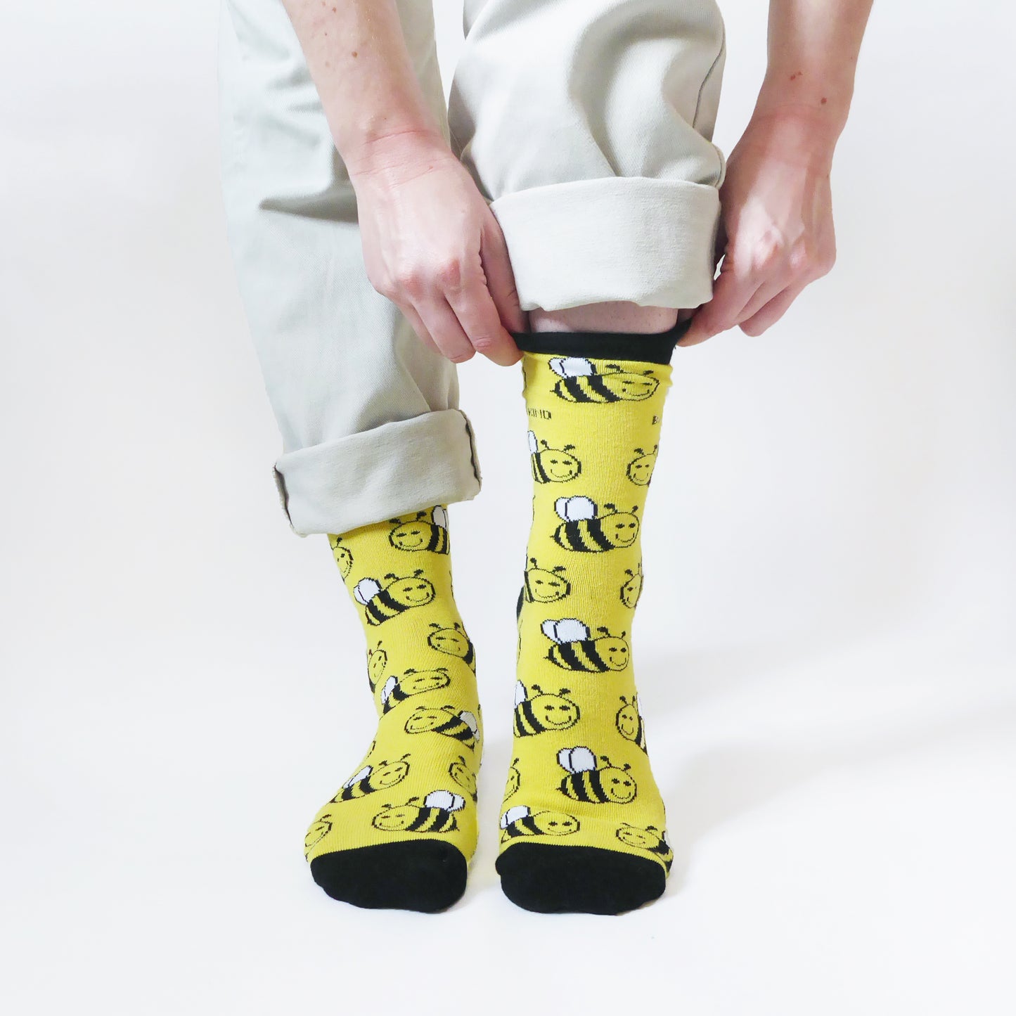 model wearing yellow bamboo socks with bee animal design 