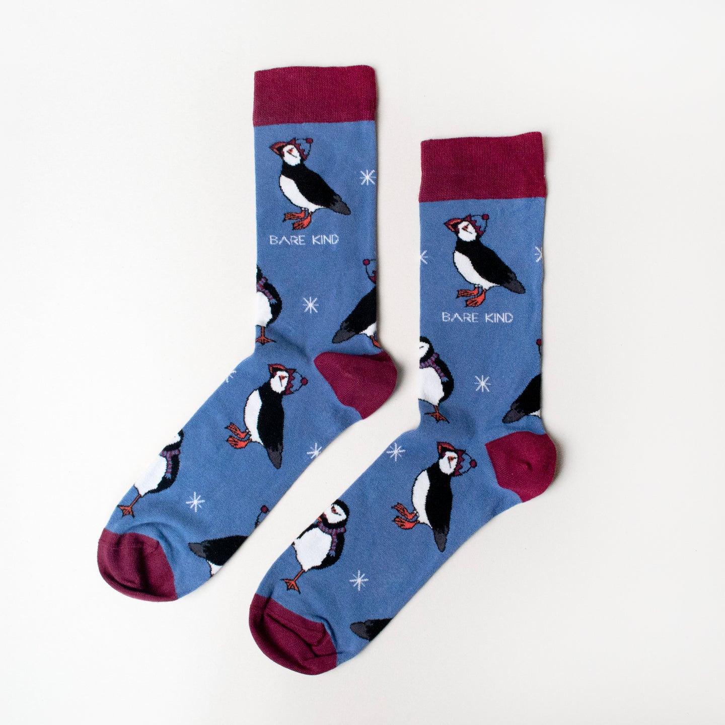 flat lay of cobalt and maroon christmas puffin socks