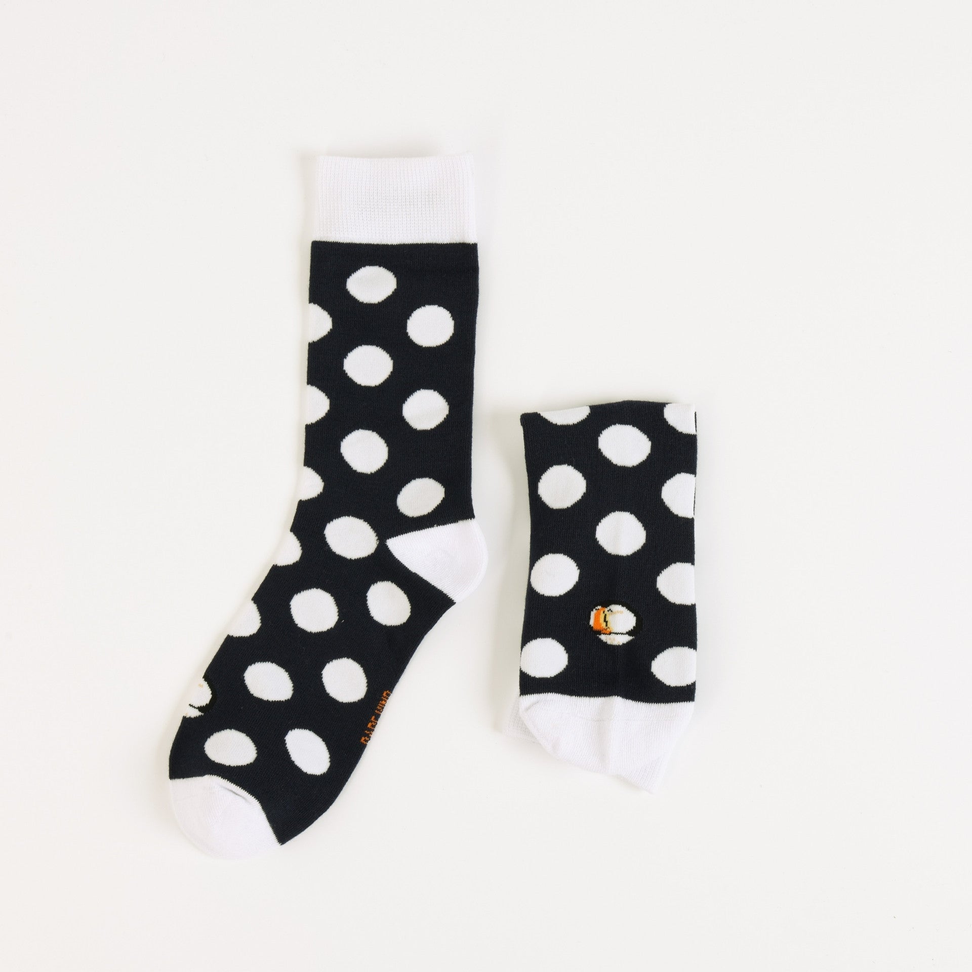 Black socks with white polka dots on a white background