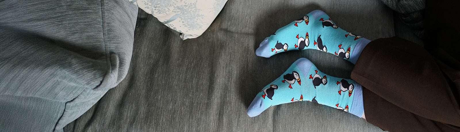 Blue puffin socks on a gray surface