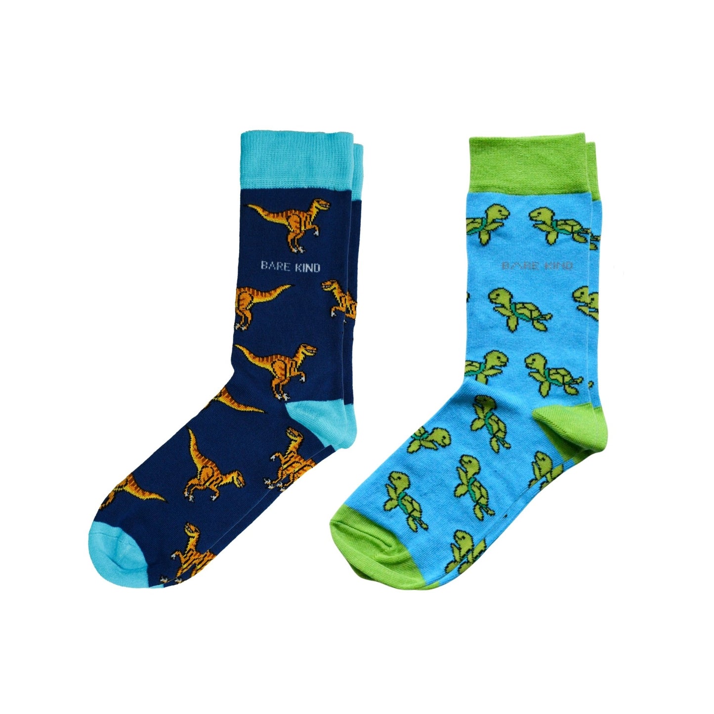 Two pairs of socks with dinosaur and turtle patterns on a white background
