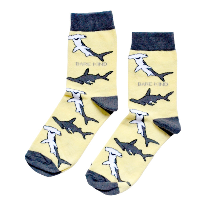 flat lay of pastel yellow shark bamboo socks with grey cuffs and heals