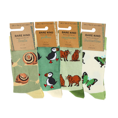 Four pairs of socks with animal designs and 'Bare Kind' packaging on a white background